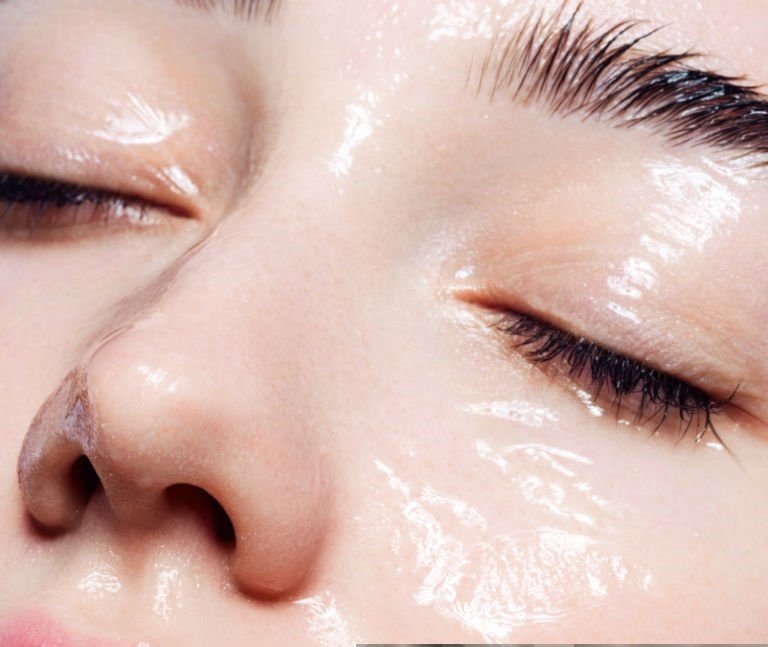 About 9 Beautiful young woman with moisturizing gel on her face